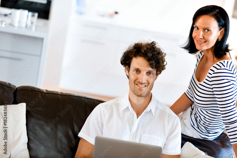 Couple at home using laptop Couple at home using laptop
