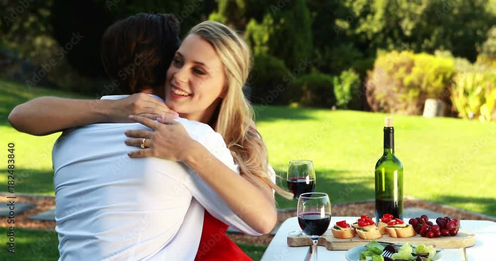 Man putting an engagement ring on womans hand Man putting an engagement ring on womans hand