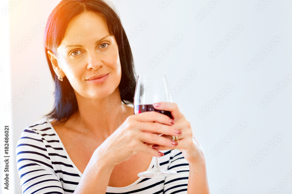 Beautiful young woman holding glass with red wine Beautiful young woman holding glass with red wine
