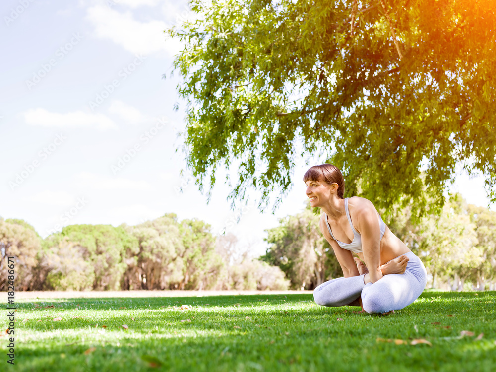 Young woman practicing yoga in the park