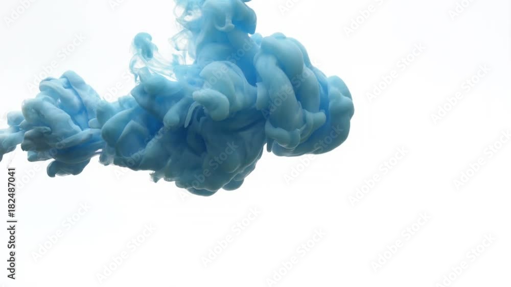 Blue ink dropped in water on white background