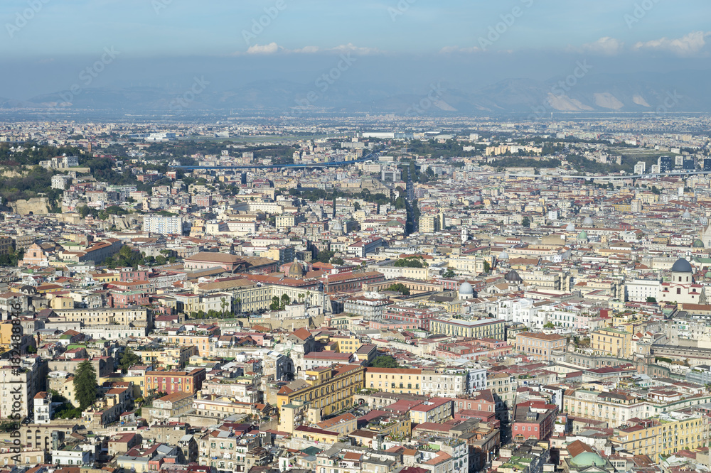 Scenic landscape view across the historic city centre of Naples, Italy to Mount Vesuvius on the horizon