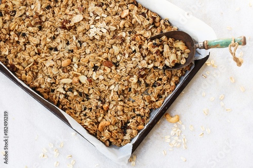 Valokuva Homemade Granola in a parchment lined baking sheet, selective focus
