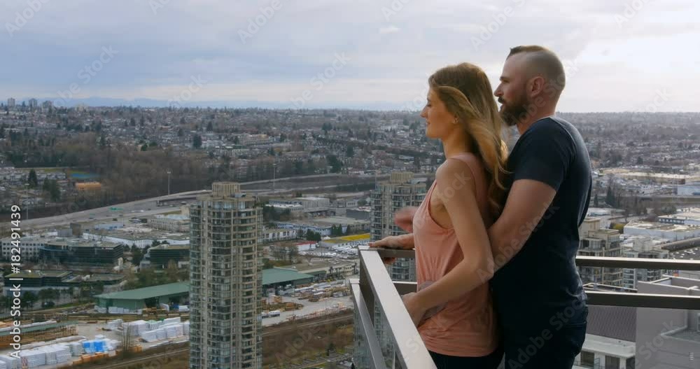Couple pointing at distance in balcony Couple pointing at distance in balcony