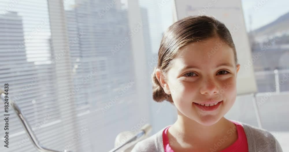 Girl as female executive smiling at camera in office Girl as female executive smiling at camera in office