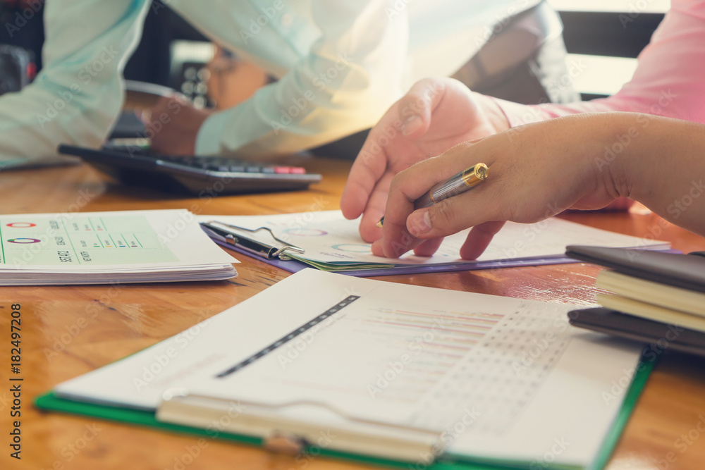 Business and finance concept of office working,Teamwork of Businessmen using calculator to discussing analysis Chart Business and finance concept of office working,Teamwork of Businessmen using calculator to discussing analysis Chart