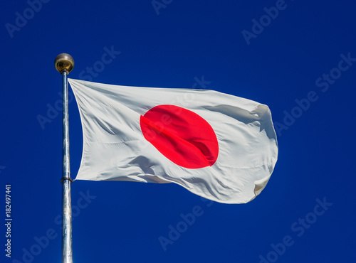 National Flag of Japan with the Red Sun waving in the wind  photo