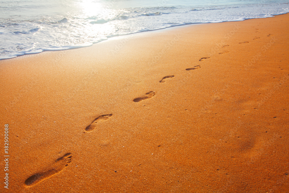beach, wave and footprints at sunset time beach, wave and footprints at sunset time