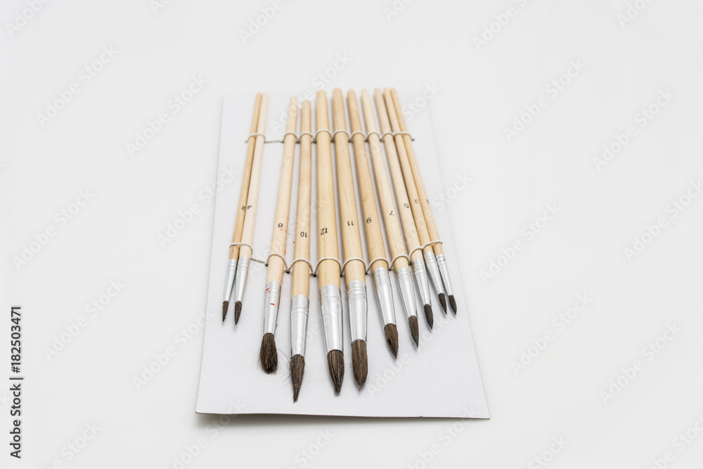 Set of Old and Used Paint Brushs in different sizes, on white background Set of Old and Used Paint Brushs in different sizes, on white background