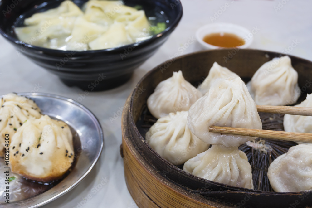 Enjoying traditional Shanghai food including dumpling, wonton and xiaolongbao