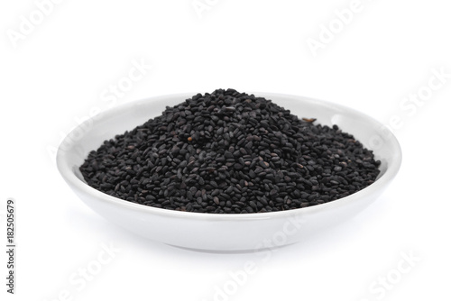 black sesame seeds in the white bowl isolated on white background