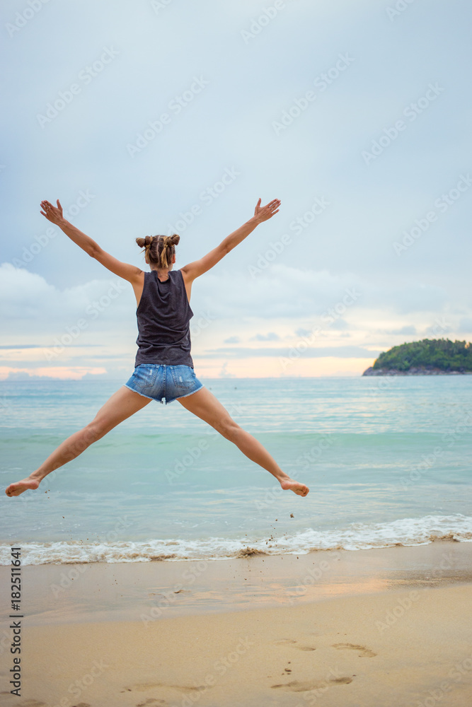 Young girl on blue sea background. Tropical country. Beach waves. Sunset. Dawn. Thailand Phuket Kata Young girl on blue sea background. Tropical country. Beach waves. Sunset. Dawn. Thailand Phuket Kata