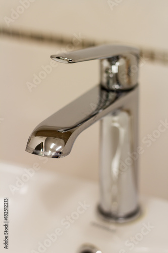  Silver faucet over a sink closeup