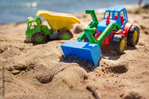 Children's toy on sand,industrail symbols.