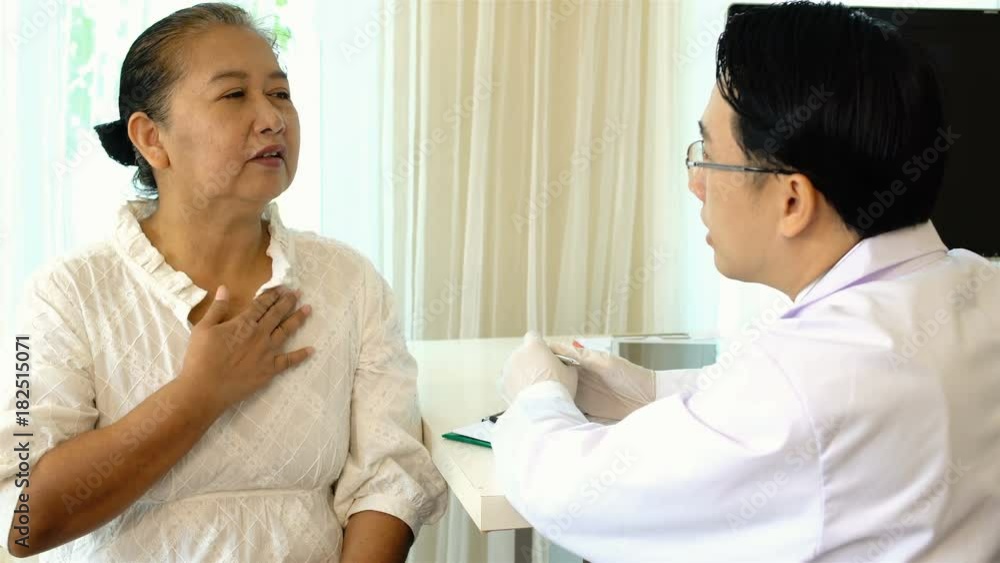 Young doctor is questioning the symptoms of the female patient Young doctor is questioning the symptoms of the female patient