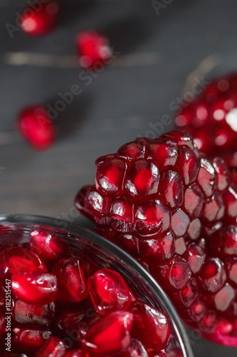 Glass filled with pomegranate seeds on the table