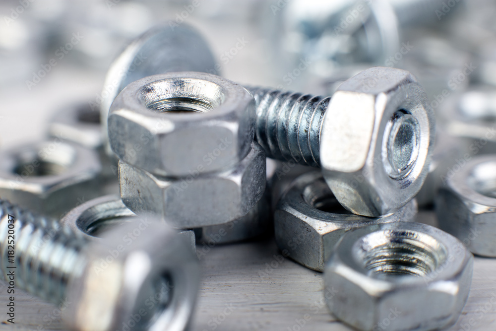 Metal nuts and bolts background. Macro. Working tools. Fixing elements. Metal nuts and bolts background. Macro. Working tools. Fixing elements.