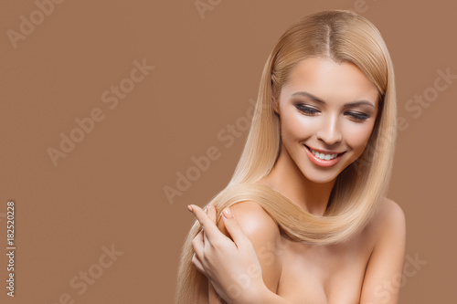 portrait of beautiful blonde long hair girl with closed eyes isolated on beige