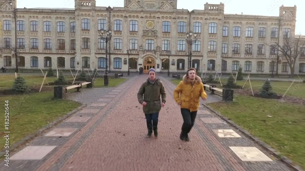 Two students runs to home after university Two students runs to home after university