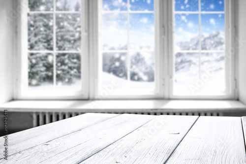 winter window and white wooden desk space 
