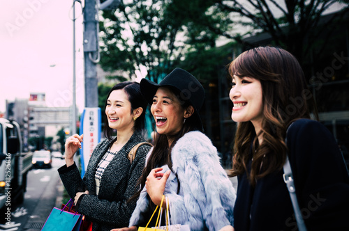 Group of japanese women spending time in Tokyo, making shopping in differents areas of the city photo