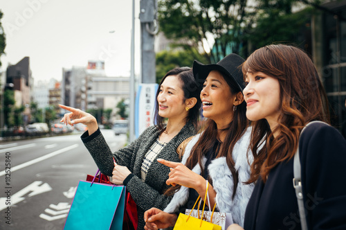 Group of japanese women spending time in Tokyo, making shopping in differents areas of the city photo