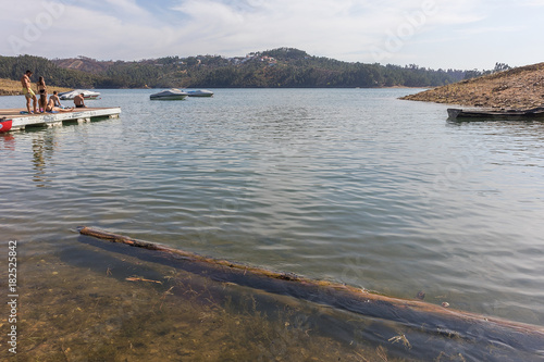 Lake with wood trunk floating. photo