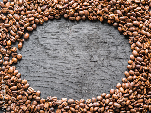 Roasted coffee beans arranged as a frame. Top view.