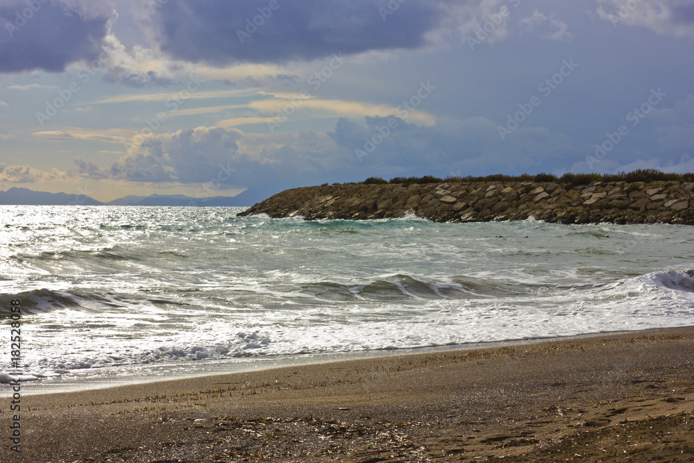 Stormy winter Mediterranean sea and empty sandy beach