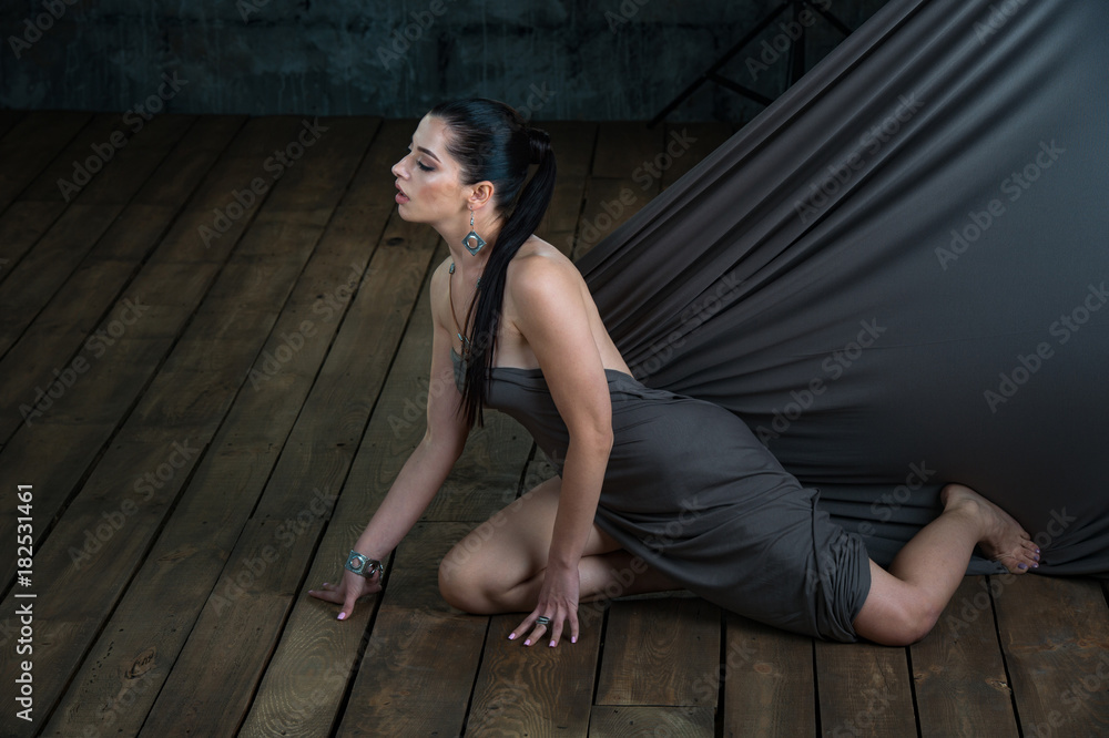 Pretty young brunette wearing luxury silver accessory and jewelry. Girl Isolated on dark background Pretty young brunette wearing luxury silver accessory and jewelry. Girl Isolated on dark background