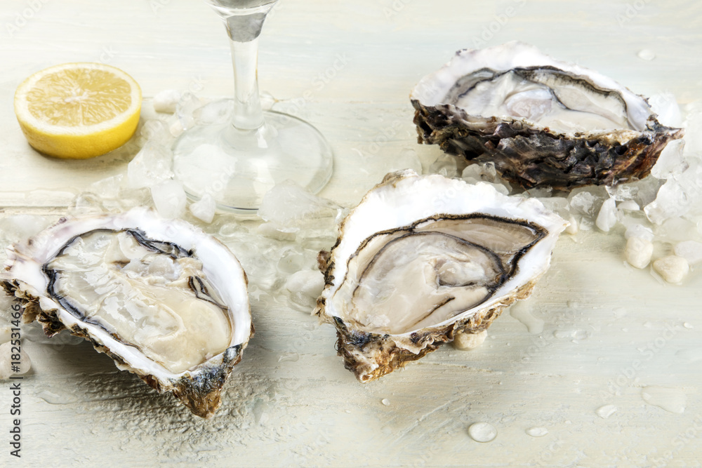 Closeup photo of oysters with wine and lemon Closeup photo of oysters with wine and lemon