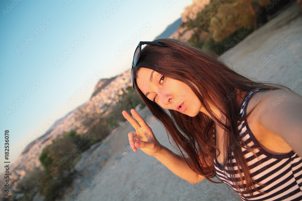 Girl taking self portrait on the background of Athens sights,Greece.Travel selfie. Girl taking self portrait on the background of Athens sights,Greece.Travel selfie.