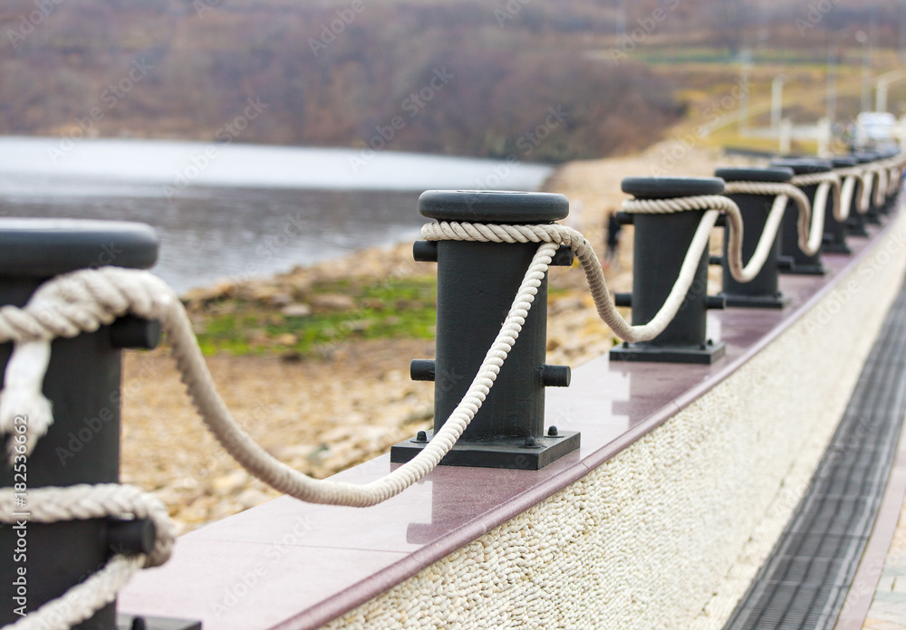bollards with ropes on a quay for decorative fencing. bollards with ropes on a quay for decorative fencing.