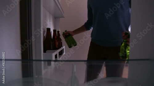 Close up of man taking beer from the fridge