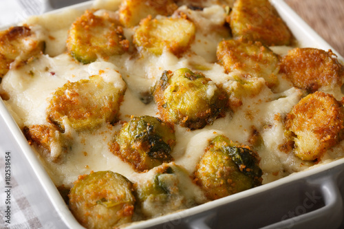 casserole from Brussels sprouts with garlic, cream sauce close-up. horizontal