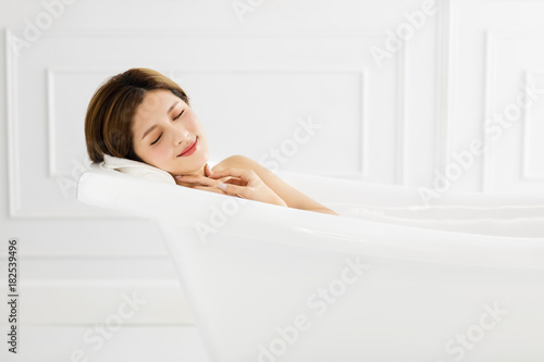 young Beautiful woman relaxing in bathtub