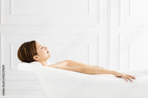 young Beautiful woman relaxing in bathtub.