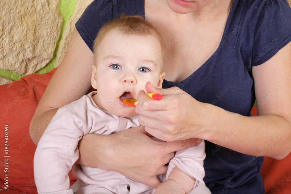 Mother and child - Baby eats from spoon Mother and child - Baby eats from spoon