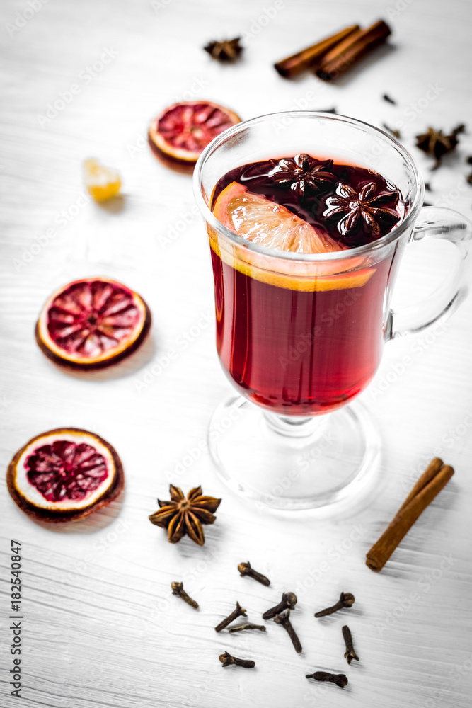 mulled wine with spices in cup on wooden background mulled wine with spices in cup on wooden background