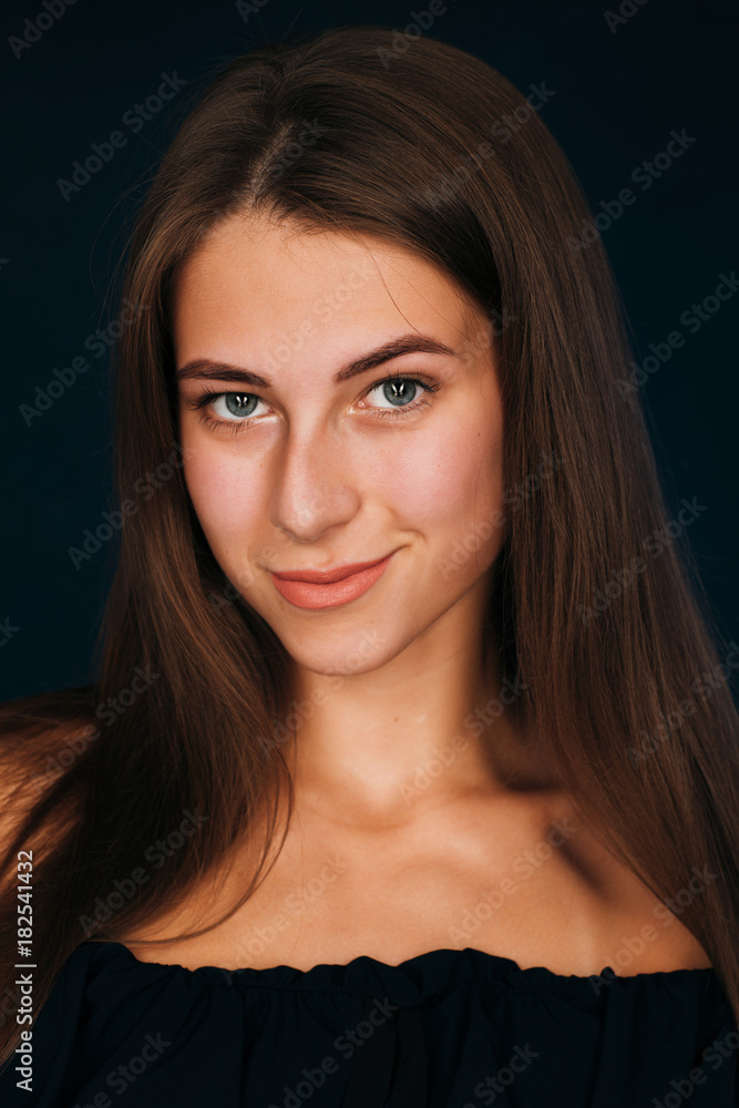 Portrait beautiful girl on a dark studio background Portrait beautiful girl on a dark studio background