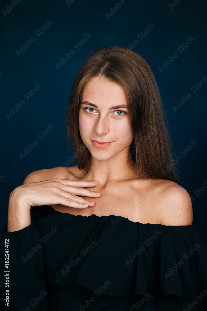 Portrait beautiful girl on a dark studio background Portrait beautiful girl on a dark studio background