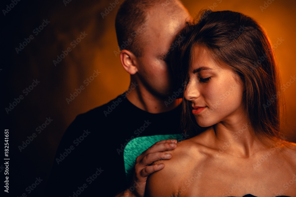 Girl and boy on the background of a sunset color