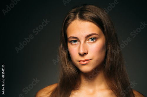 Portrait beautiful girl on a dark studio background