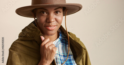 pretty mixed race woman with short hair in autumn outwear and hat
