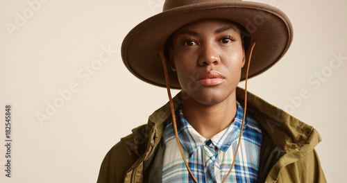 pretty mixed race woman with short hair in autumn outwear and hat