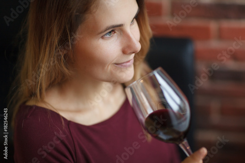 Attractive woman drink red wine in the restaurant