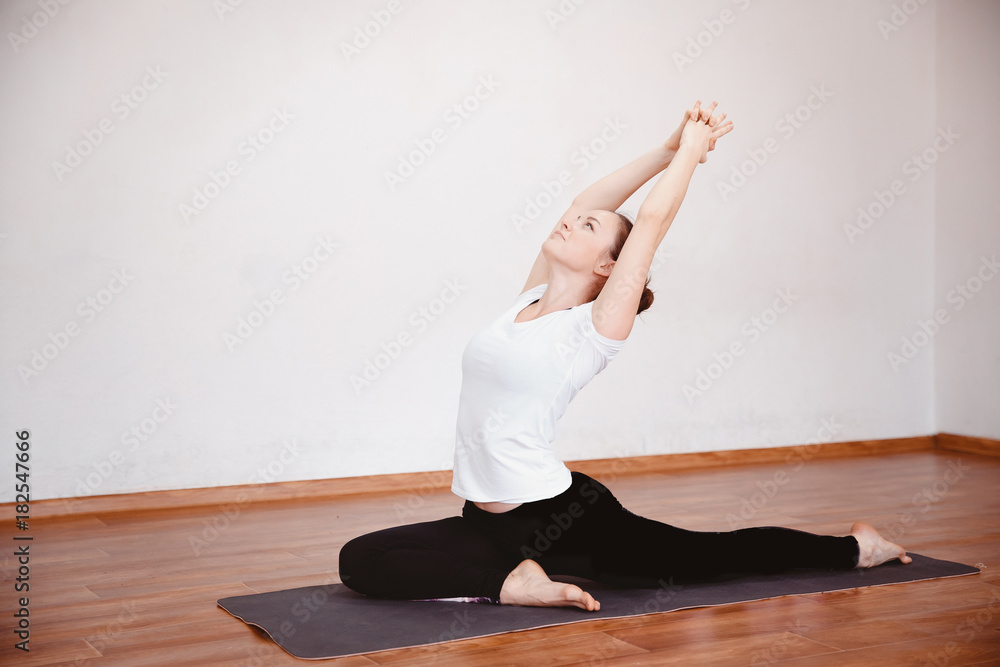 Yoga Concept. Close up woman meditates while practicing yoga in training hall or home.