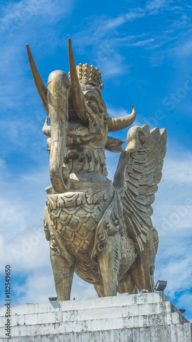Lembuswana statue, Kutai's mythological animal who has head of lion with crown, elephant trunk, fish scales, and eagle wings, in a bright sunny day, Pulau Kumala, Tenggarong, Indonesia photo