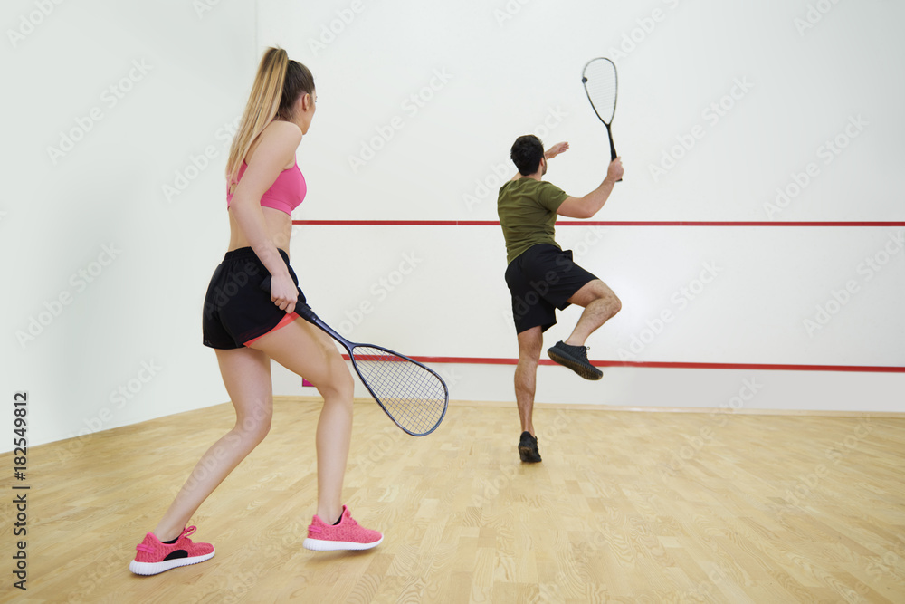 Rear view of couple during the squash game Rear view of couple during the squash game
