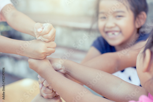Children playing and holding hands together,stack of children's fist hands